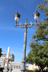 Classic lamppost of gray color of two lamps of the city Maceio.