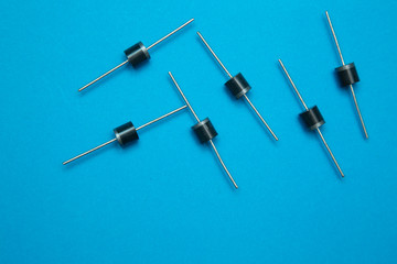 Diodes, electronic components, on a blue background.