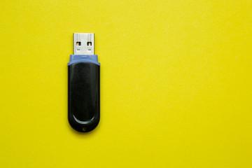 Flash drive, information storage , on a yellow background.