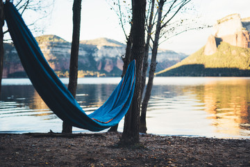 hammock for relaxing on nature lake, chilling outdoor, traveler recreation mountain landscape; camping lifestyle; enjoy weekend holiday