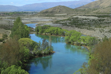 Blue river flowing to the desert mountains