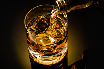 glass of whiskey on black background	