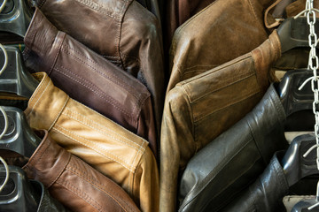colored leather jackets are displayed in the street at Lorenzo Market, in Florence, Italy