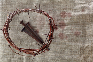 Crown of thorns with nails on textile background. Easter background. Jesus Christ.