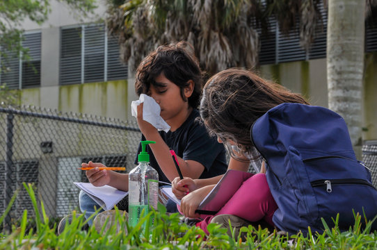 Coronavirus Kids Abandoned School Young Boy Girl Sneeze Tissue Writing Head Down Sanitize Bothered Writing Homework Waiting Mom