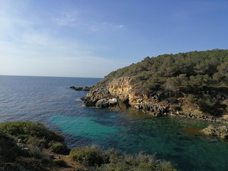Seaview of the beach of the Mallorca coastline with turquoise waters and blue sky 