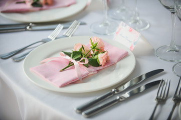 Banquet service with pink napkins, glasses, pink bouquets. Different meals for breakfast or lunch time. Wedding evening