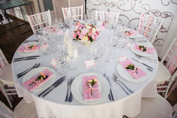 Banquet service with pink napkins, glasses, pink bouquets. Different meals for breakfast or lunch time. Wedding evening