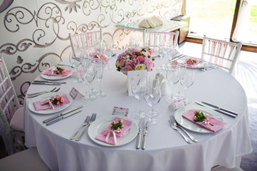 Banquet service with pink napkins, glasses, pink bouquets. Different meals for breakfast or lunch time. Wedding evening