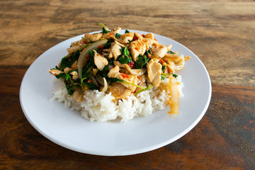 Rice topped with stir fried chicken and basil