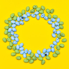 Colorful easter egg with round frame on yellow paper background