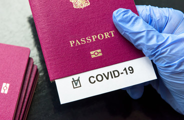 COVID-19 coronavirus pandemic and travel concept, COVID-19 note in passport. Novel corona virus...