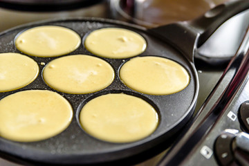 pancake frying pan with smile face pancake cooking on cooker in kitchen