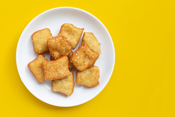 Chinese deep fried dough sticks with white sesame seeds.