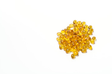 A bunch of transparent tablet of yellow color on a white background. View from above