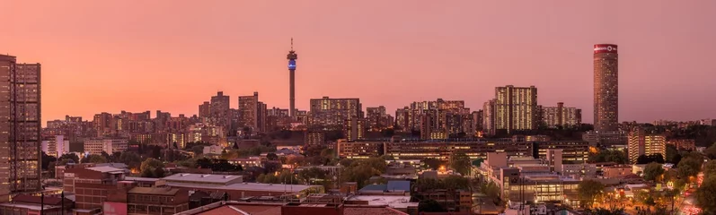 Poster A beautiful and dramatic panoramic photograph of the Johannesburg city skyline, taken on a golden evening after sunset. © Udo Kieslich