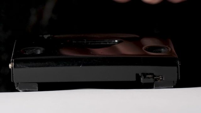 Pressing perforator with hand, punching paper documents. Close up