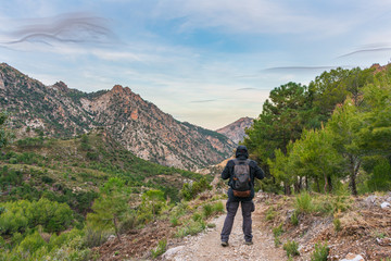 Hiker with backpack on a mountain path