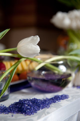 Beautiful fresh spring white tulips for Mother's Day in glass vase on a table. Wedding day, decoration