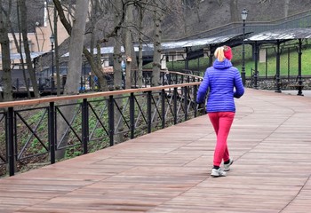 blonde girl jogging in the park