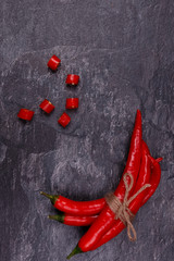 Whole and sliced red pods of chili pepper.