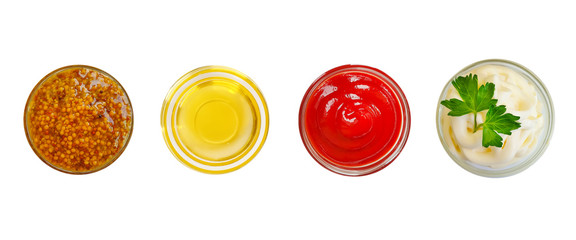 oil, mustard, ketchup, mayonnaise in a glass isolated