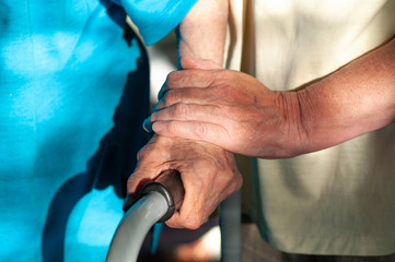 Hands of an old man on a walker. Retirement care. Enhanced care for the elderly. Coronovirus takes old people