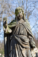 Fototapeta na wymiar Historic Jesus on the mystery old Prague Cemetery, Czech Republic
