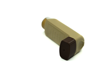 A brown asthma inhaler isolated on a white background