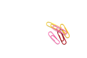 Colored paper clips on white background