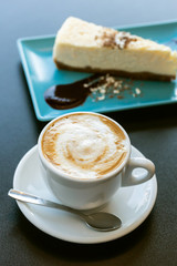 Cake and cappuccino coffee on the table