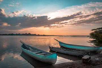 Fototapeta na wymiar two light blue boats during the sunset