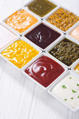 Set of different sauces in ceramic bowl