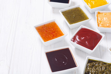 Set of different sauces in ceramic bowl