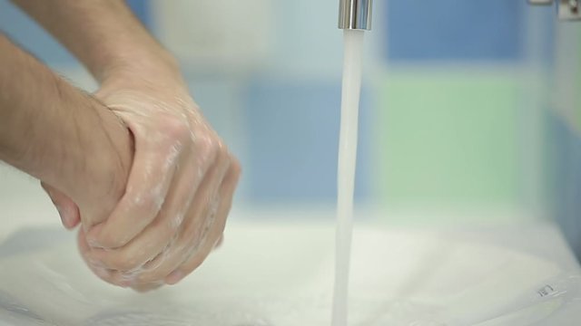 Closeup of man washing hands