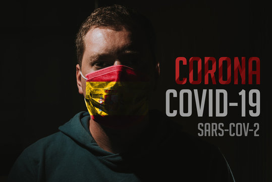 man wearing mask with Spain flag for protection of corona virus covid-19 SARS-CoV-2