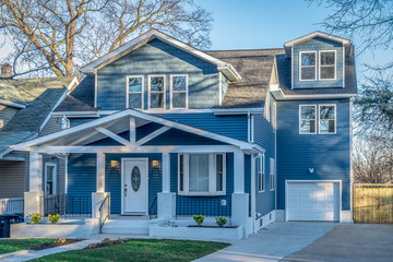Wonderfully restored Craftsman home with horizontal lines, low-pitched gable roofs that extend far out past the home’s exterior walls with exposed beams decorative elements such as brackets, lintels, 