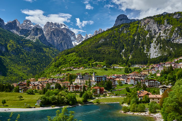 Aerial view over the beautiful Molveno town and Molveno lake, an alpine lake in Trentino, Italy