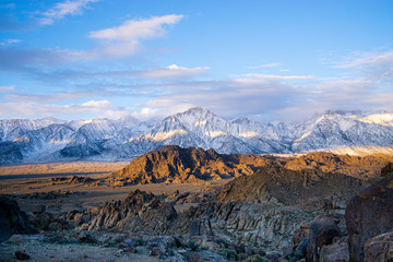 Mt. Whitney in the early morning with clouds around the peak but from farther away