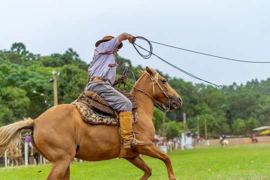 man riding a horse at a Creole rodeo "rodeio crioulo"