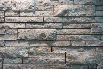 Grey Stone Wall Texture with Bricks of Different sizes meshing together for unique tile pattern