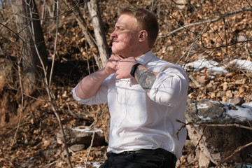 a blond man in a white shirt is laughing and smiling