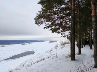 on a gloomy winter day by a frozen river