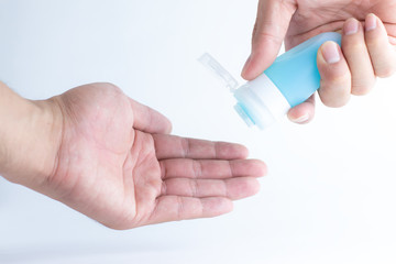 Hand cleaning gel. Pouring sanitising hand gel onto the hands of a hand. Cleaning germs on the hands using alcohol.