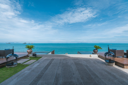 Outdoor terrace against blue ocean and sky, in a tropical island resort
