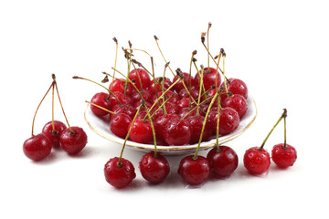 Obraz na płótnie Canvas Red cherries on dish