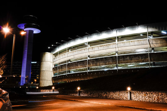 Stockholm, Sweden  The control tower and a parking garage at night.