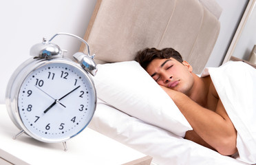 Young man having trouble waking up in the morning