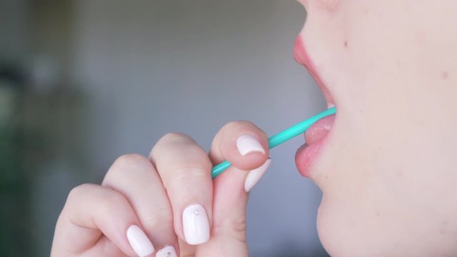 female sexy lips suck off a round lollipop. Cute Woman with sweet sugar candy closeup.
