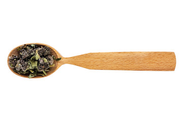 Dried Stachys officinalis or betony in a wooden spoon on a white background. The view from the top